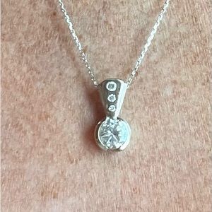 14K white gold pendant with large CZ brilliant stone and 3 smaller stones above.